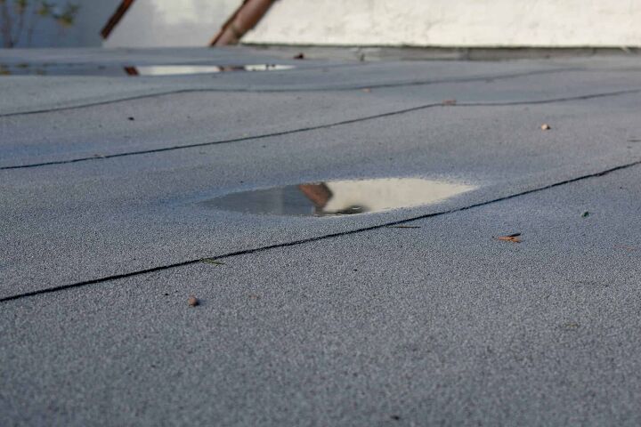 flat roof leaks in heavy rain possible causes fixes