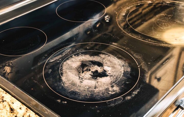 Dirty and Damaged Induction Stove in Kitchen